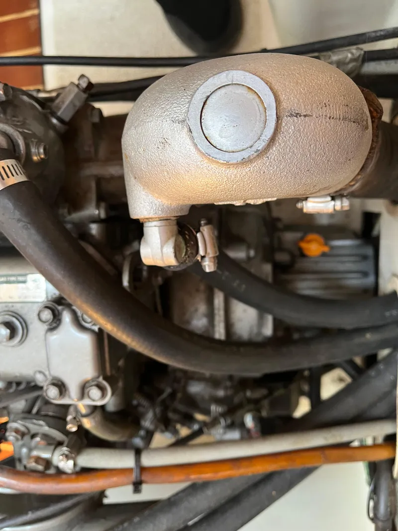 Slide: The Image of Close-up of a 1988 Tartan 31 engine with visible hoses and components. - 21