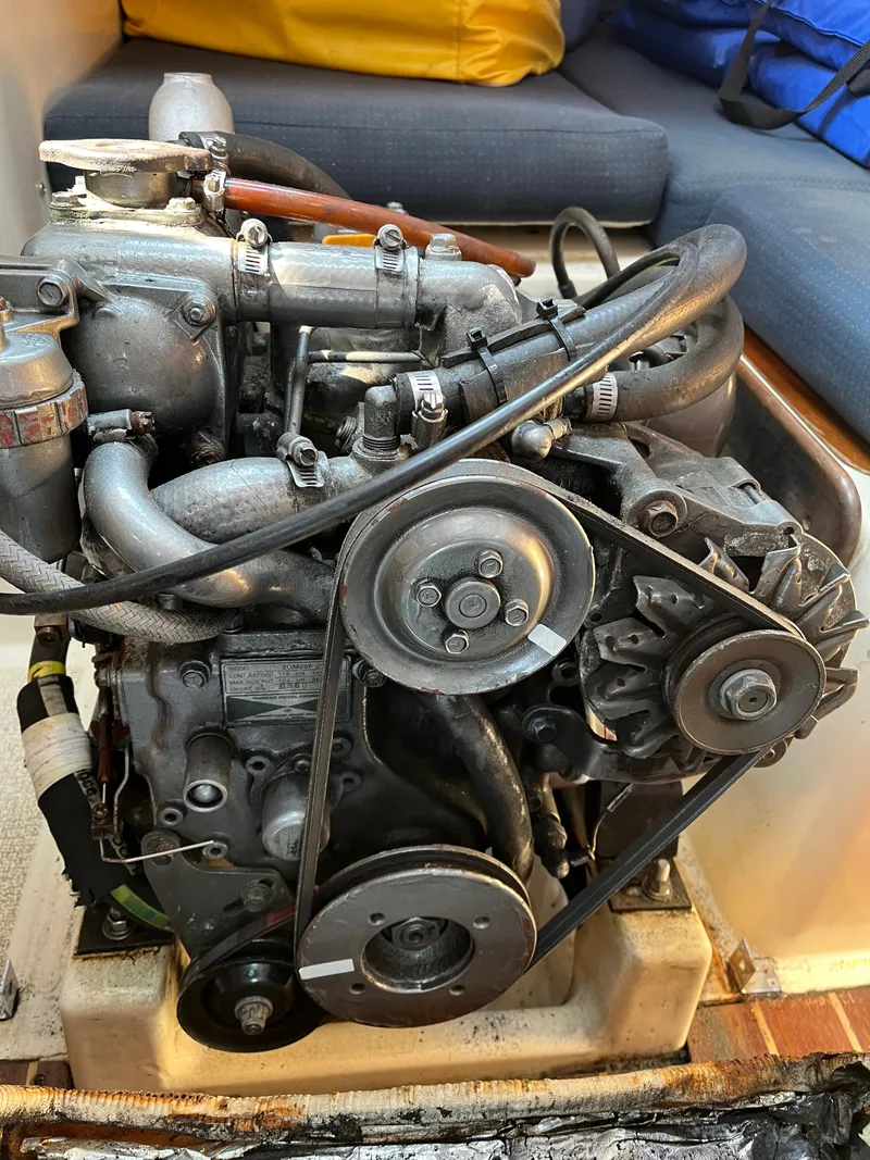 Slide: The Image of Engine of a 1988 Tartan 31 sailboat, showcasing belts and components. - 22