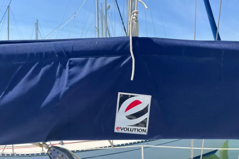 Slide: The Image of Blue sail cover with "Evolution" logo on a 1988 Tartan 31 sailboat. - 24