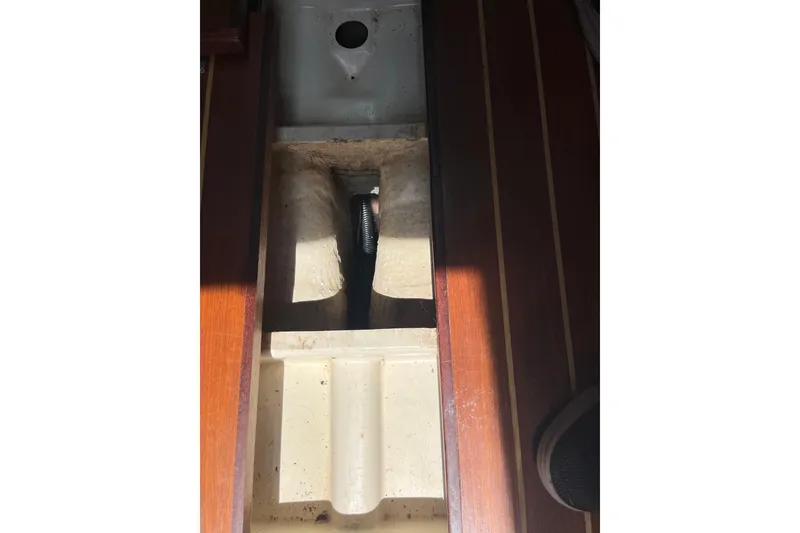 Slide: The Image of Interior view of a 1988 Tartan 31 sailboat, showing a compartment with wooden flooring. - 27