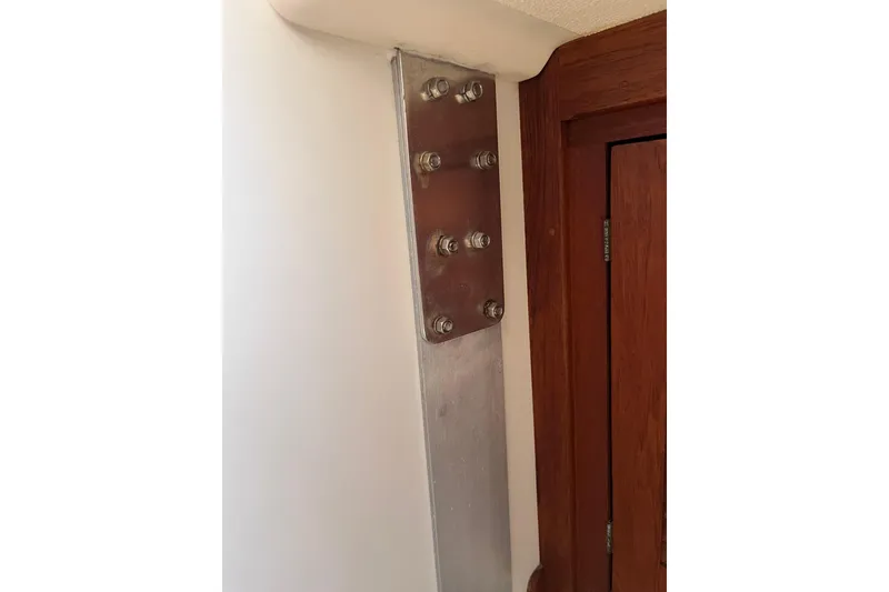 Slide: The Image of Metal support bracket with bolts on a 1988 Tartan 31 sailboat interior wall. - 28