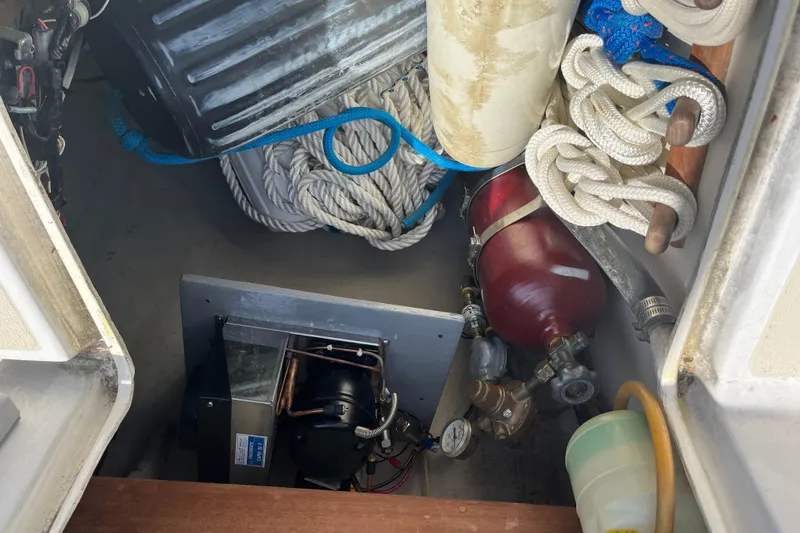 Slide: The Image of Storage compartment of a 1988 Tartan 31 sailboat with ropes and equipment. - 36