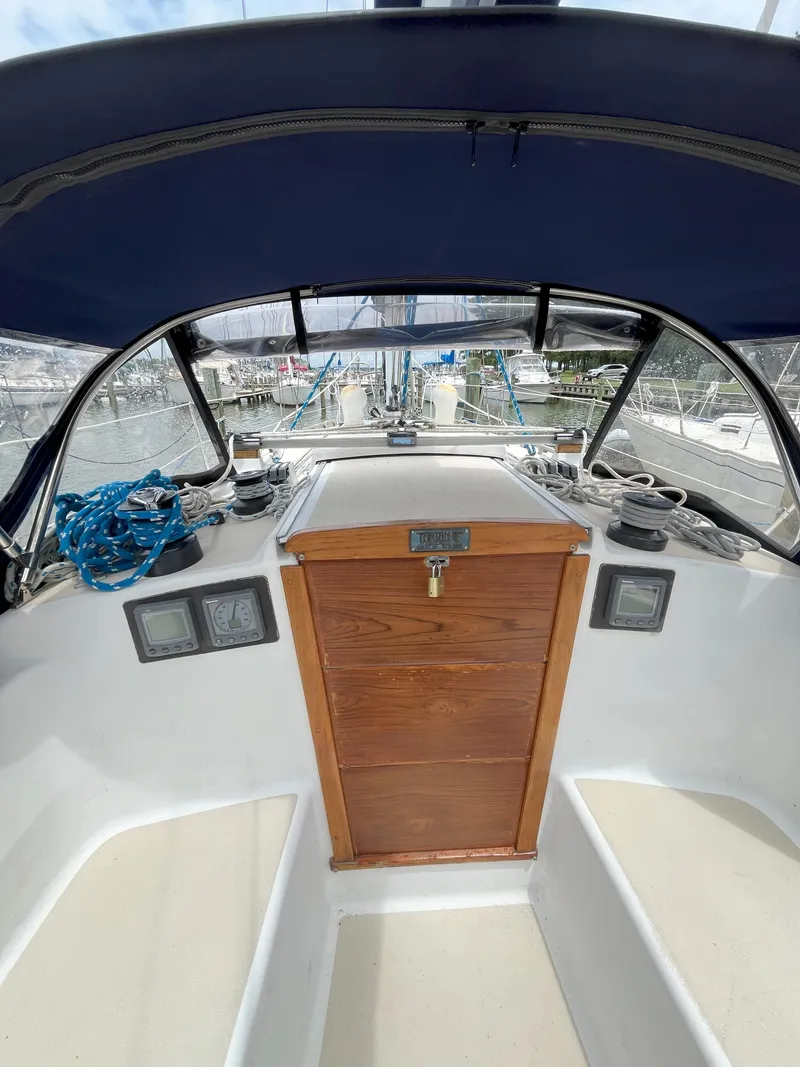 Slide: The Image of Cockpit of 1988 Tartan 31 sailboat with blue canopy and wooden hatch. - 7