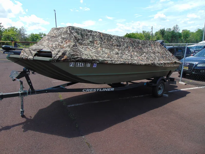 Slide: The Image of 2016 Crestliner 1860 Retriever Jon Deluxe boat with camouflage cover on trailer. - 12