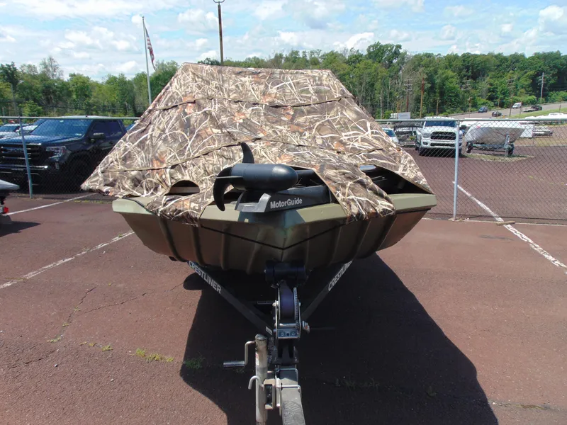 Slide: The Image of 2016 Crestliner 1860 Retriever Jon Deluxe boat with camouflage cover in parking lot. - 13