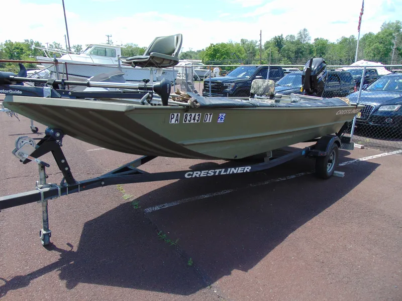 Slide: The Image of 2016 Crestliner 1860 Retriever Jon Deluxe boat on trailer, parked outdoors. - 3