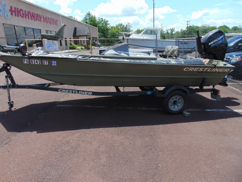 Slide: The Image of 2016 Crestliner 1860 Retriever Jon Deluxe boat on trailer, parked outside Highway Marine. - 4