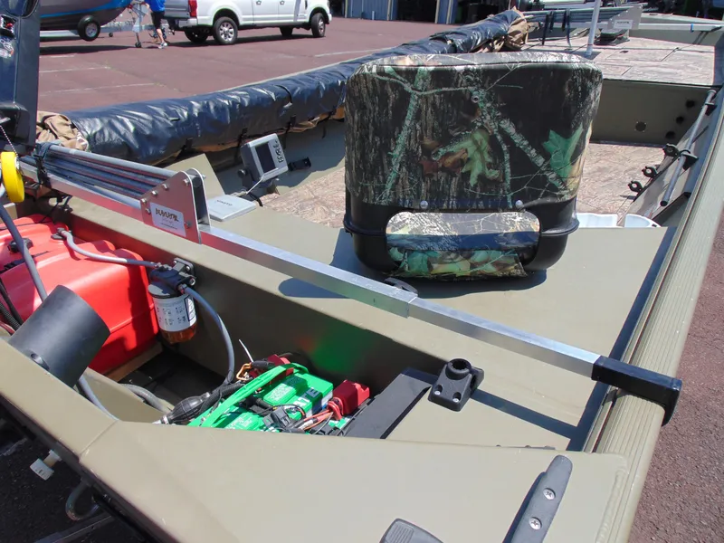 Slide: The Image of 2016 Crestliner 1860 Retriever Jon Deluxe boat interior with camo seat and equipment. - 7