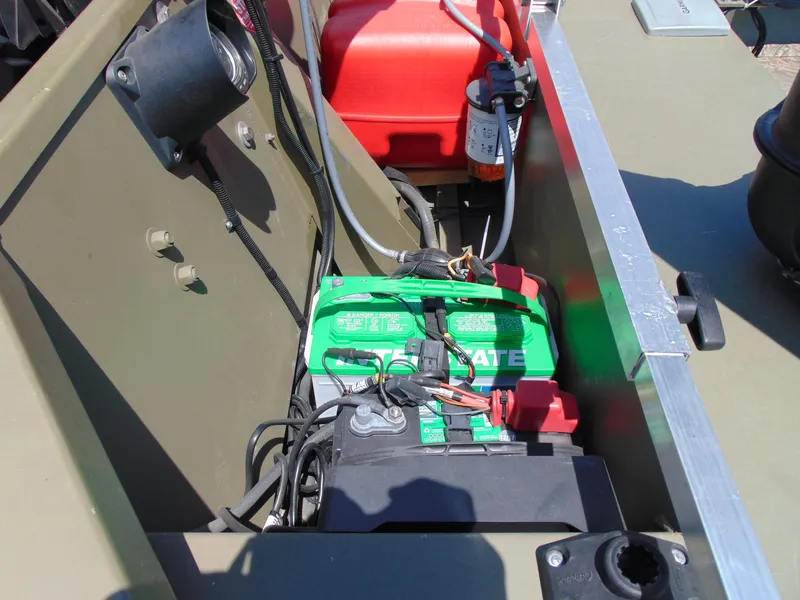 Slide: The Image of 2016 Crestliner 1860 Retriever Jon Deluxe boat battery compartment with wiring and fuel tank. - 8