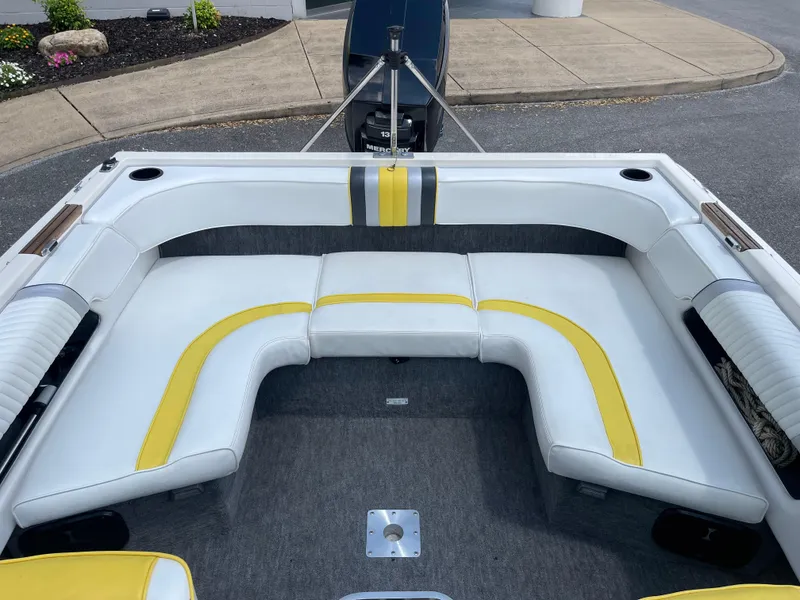 Slide: The Image of 1990 Sea Ray 180 Bow Rider interior with white and yellow seating. - 4