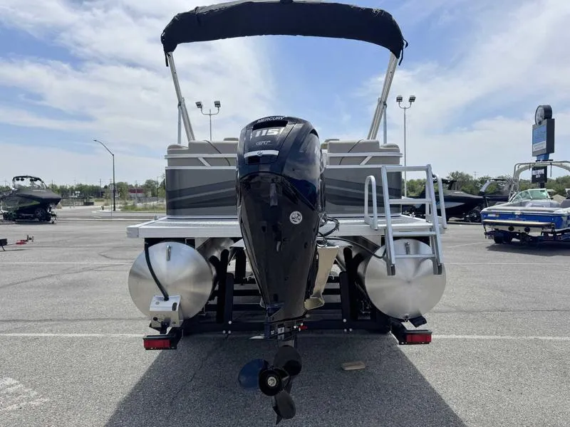 Slide: The Image of 2025 Avalon 2180 23 Venture QL pontoon boat with Mercury 115 outboard motor in a parking lot. - 5
