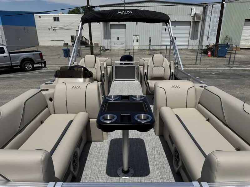Slide: The Image of 2025 Avalon 2180 23 Venture QL pontoon boat with beige seating and black canopy. - 7