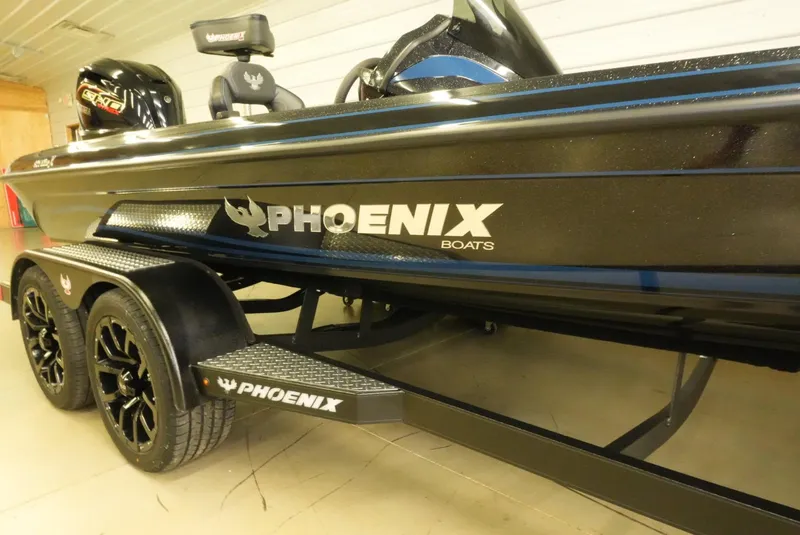 Slide: The Image of 2026 Phoenix 921 Elite X boat with sleek black design and custom trailer. - 11