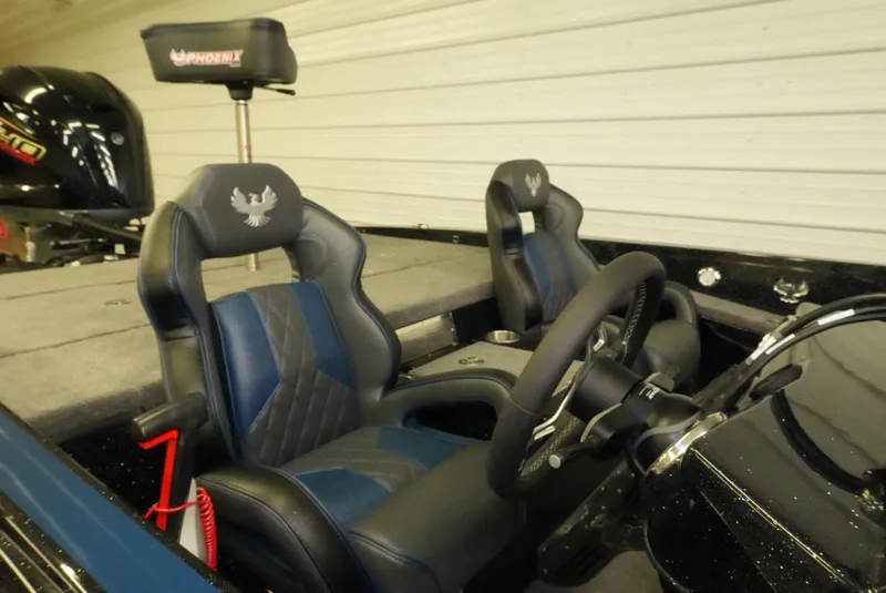 Slide: The Image of Interior of 2026 Phoenix 921 Elite X boat with sleek seats and steering wheel. - 12