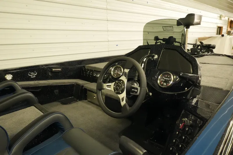 Slide: The Image of 2026 Phoenix 921 Elite X boat interior with steering wheel and dashboard controls. - 13