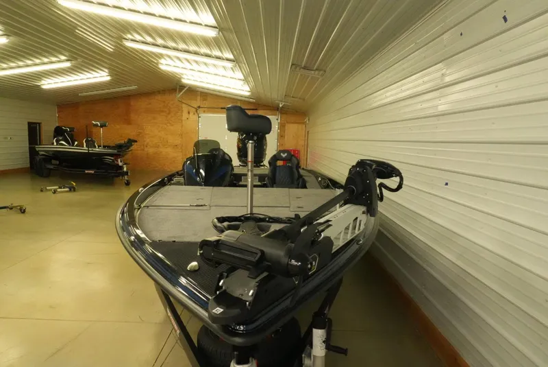 Slide: The Image of 2026 Phoenix 921 Elite X boat in a well-lit indoor storage facility. - 14