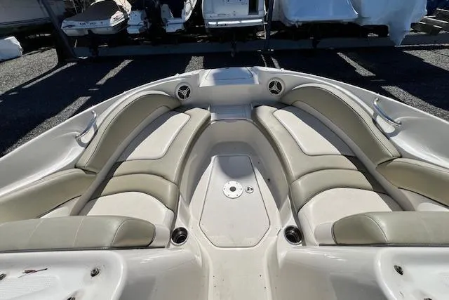 Slide: The Image of 2006 Sea Ray 220 Sundeck boat interior with spacious seating and cup holders. - 10