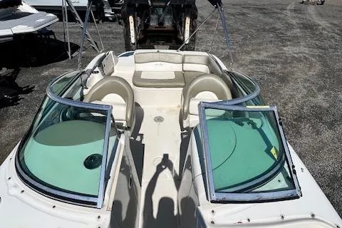 Slide: The Image of 2006 Sea Ray 220 Sundeck boat with open cockpit and seating, viewed from above. - 12