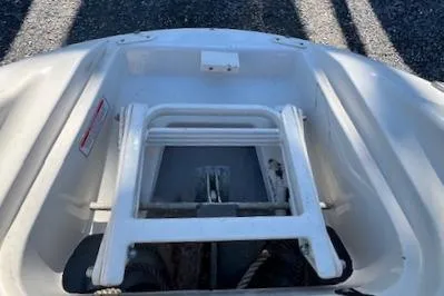 Slide: The Image of 2006 Sea Ray 220 Sundeck bow with ladder and storage compartment. - 14