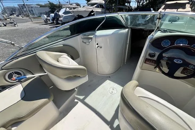 Slide: The Image of 2006 Sea Ray 220 Sundeck interior with steering wheel, seating, and dashboard. - 3