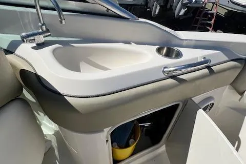 Slide: The Image of 2006 Sea Ray 220 Sundeck boat interior with sink and storage compartment. - 8