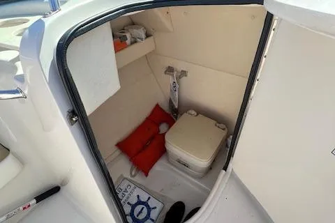 Slide: The Image of 2006 Sea Ray 220 Sundeck interior with portable toilet and safety equipment. - 9