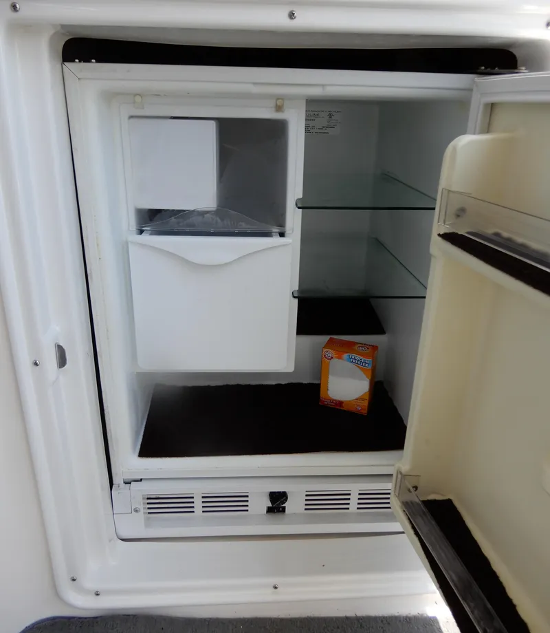 Slide: The Image of Open refrigerator in 2006 Regal Commodore 3760 IO boat, with baking soda box inside. - 13