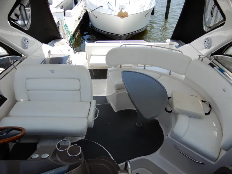 Slide: The Image of 2006 Regal Commodore 3760 IO boat interior with white seating and table. - 14