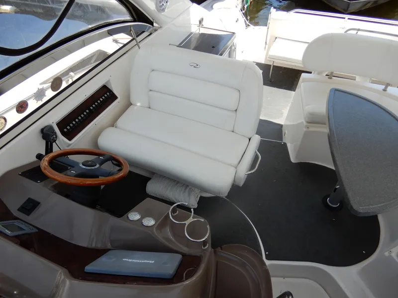 Slide: The Image of 2006 Regal Commodore 3760 IO boat interior with steering wheel and seating area. - 16