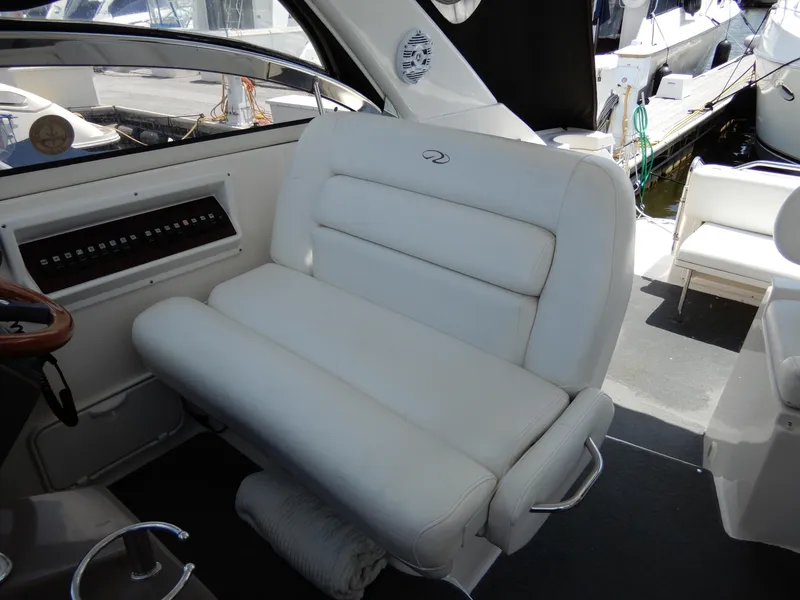 Slide: The Image of 2006 Regal Commodore 3760 IO boat interior with white leather seating and control panel. - 19