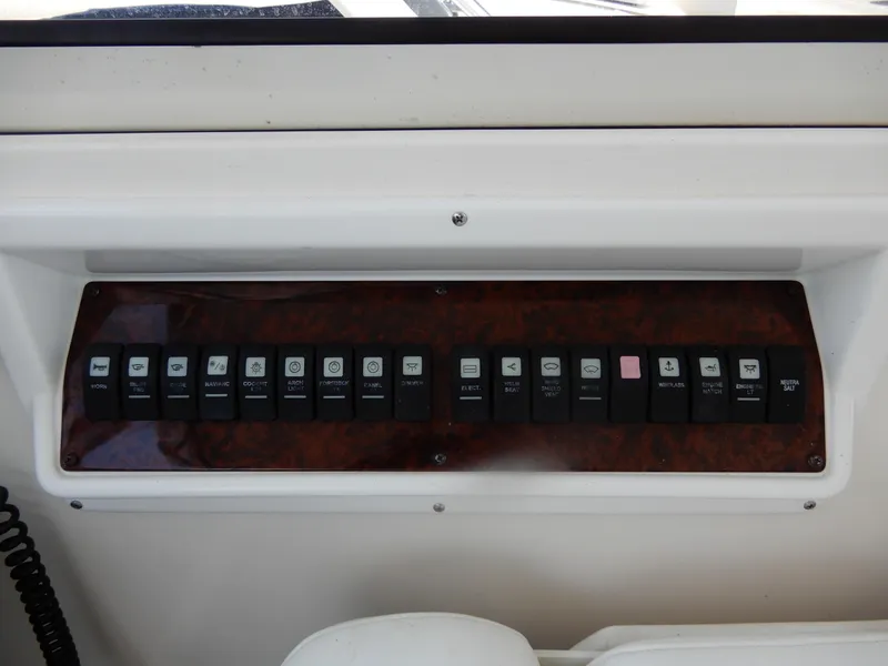 Slide: The Image of Control panel of 2006 Regal Commodore 3760 IO boat with labeled switches. - 21