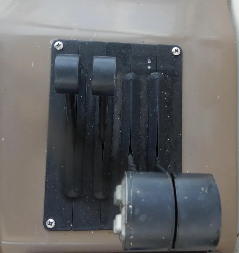 Slide: The Image of Control panel of a 2006 Regal Commodore 3760 IO boat with levers and switches. - 24