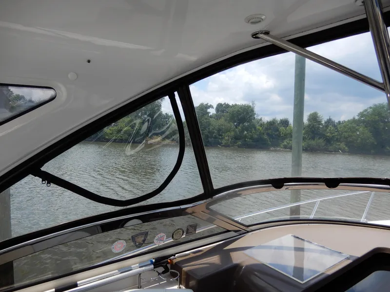 Slide: The Image of Interior view from a 2006 Regal Commodore 3760 IO boat, overlooking a serene river. - 26