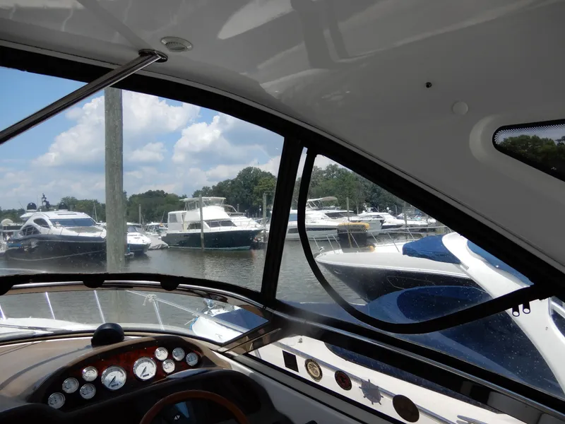 Slide: The Image of View from 2006 Regal Commodore 3760 IO boat cockpit, overlooking marina with multiple yachts. - 29
