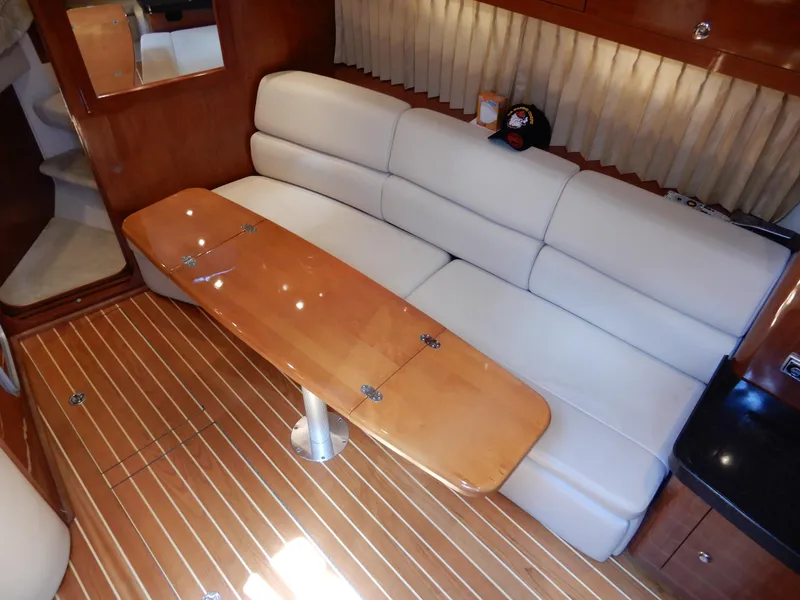 Slide: The Image of Luxurious interior of 2006 Regal Commodore 3760 IO yacht with plush seating and wooden table. - 31