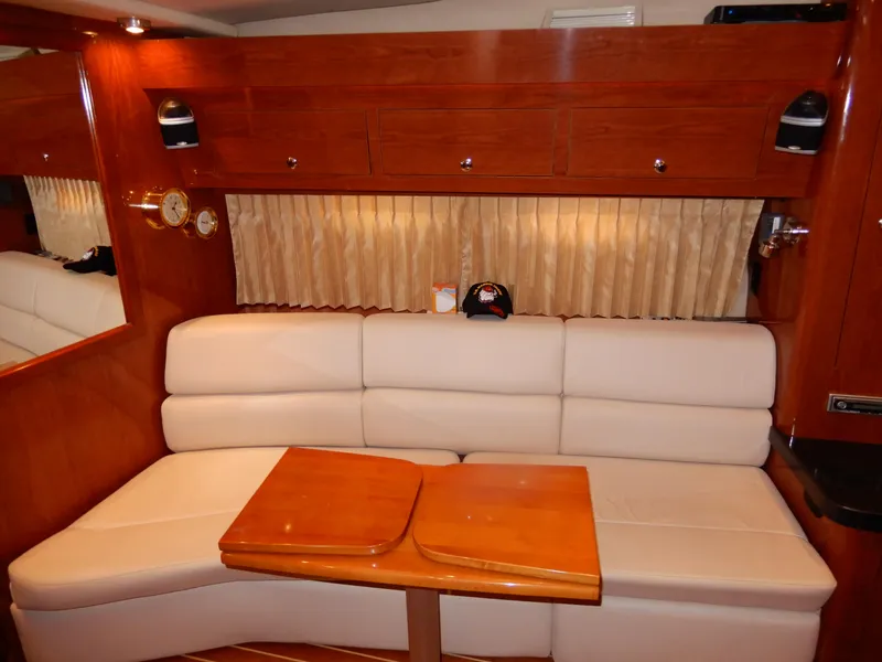Slide: The Image of Luxurious interior of 2006 Regal Commodore 3760 IO yacht with plush seating and wooden accents. - 32