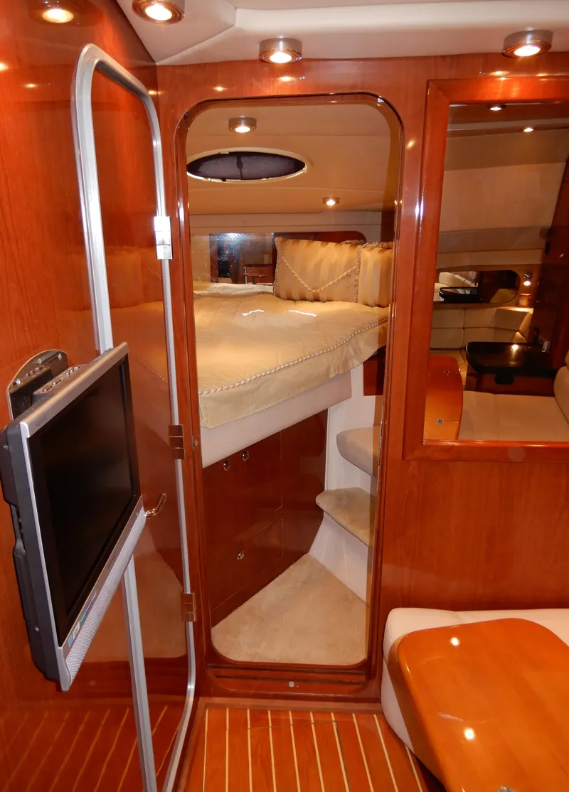 Slide: The Image of Luxurious interior of 2006 Regal Commodore 3760 IO yacht with cozy bedroom and TV. - 39