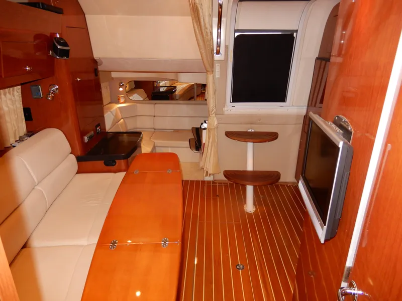 Slide: The Image of Luxurious interior of 2006 Regal Commodore 3760 IO yacht with wood finishes and seating. - 45