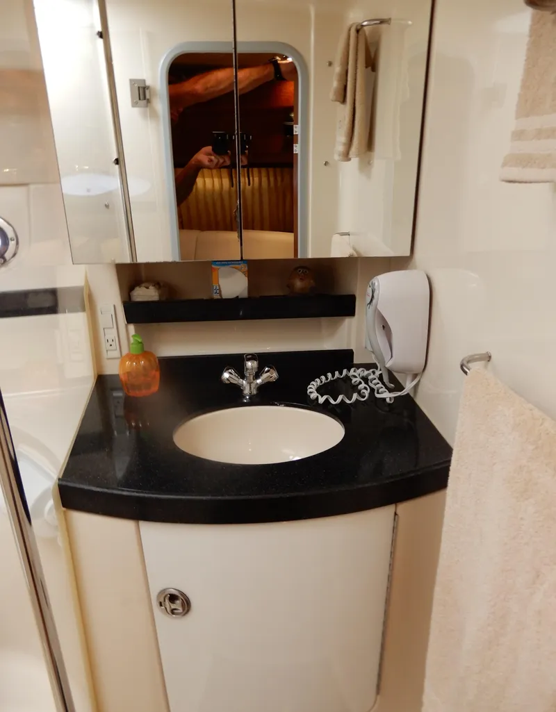 Slide: The Image of 2006 Regal Commodore 3760 IO bathroom with sink, mirror, and towel. - 49