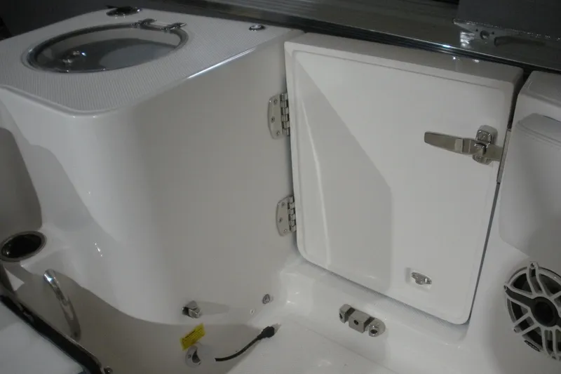 Slide: The Image of 2026 Robalo R270 Center Console boat seating, featuring white and blue cushioned design. - 14