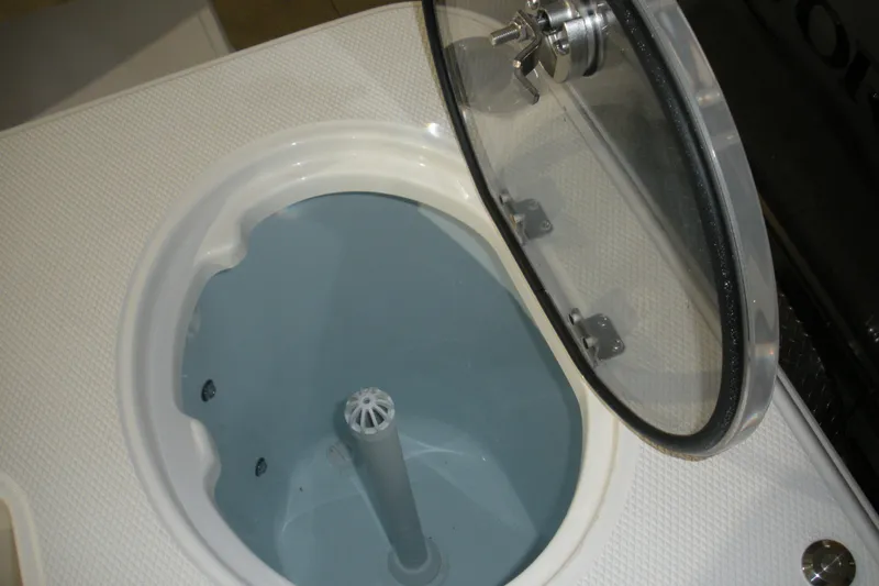 Slide: The Image of 2026 Robalo R270 Center Console storage compartment with open lid, showcasing interior design. - 15