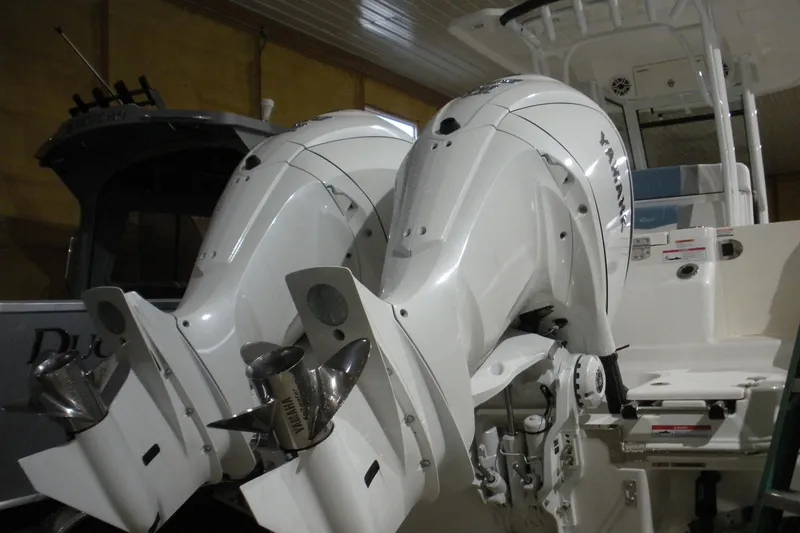 Slide: The Image of 2026 Robalo R270 Center Console with dual Yamaha outboard engines in a garage setting. - 21