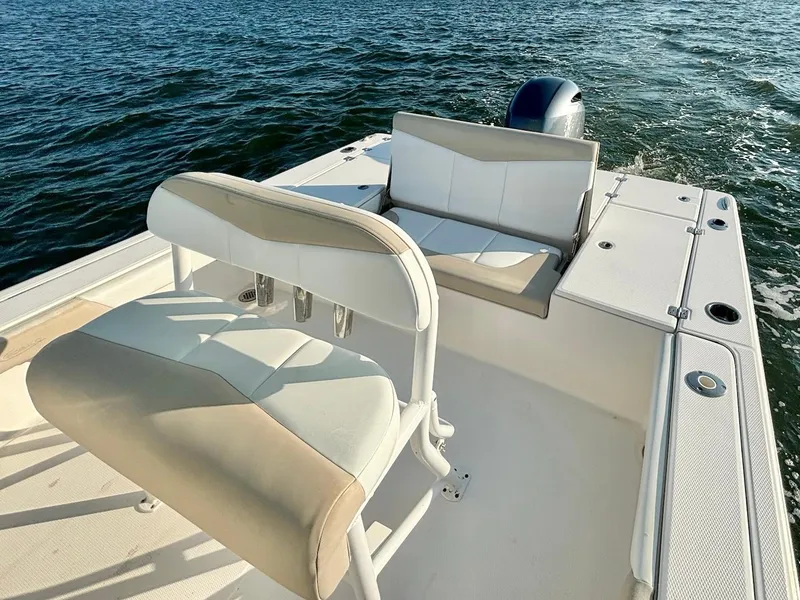 Slide: The Image of 2020 Robalo 226 Cayman boat interior with seating, on open water. - 10