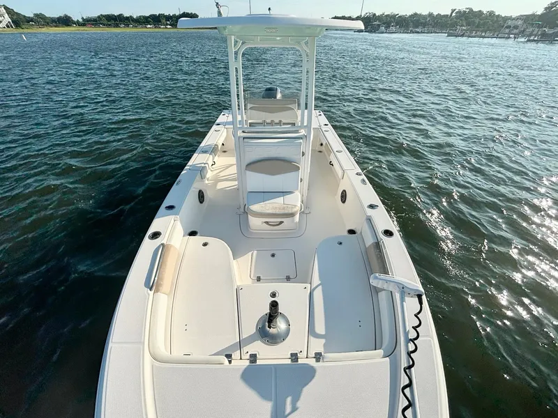 Slide: The Image of 2020 Robalo 226 Cayman boat on water, showcasing spacious deck and seating. - 12