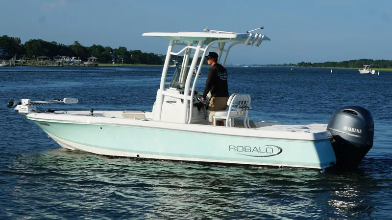 Slide: The Image of 2020 Robalo 226 Cayman boat on water with Yamaha engine, piloted by a person. - 3