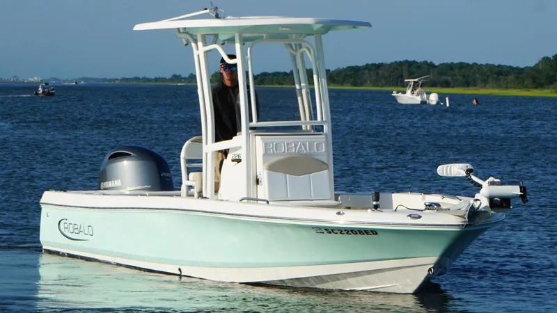 Slide: The Image of 2020 Robalo 226 Cayman boat on water, featuring Yamaha engine and T-top canopy. - 5