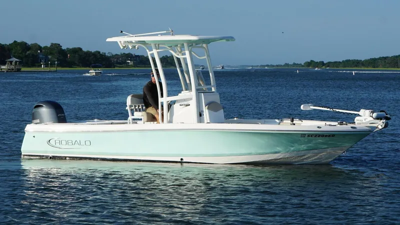 Slide: The Image of 2020 Robalo 226 Cayman boat on calm water, featuring a sleek design and Yamaha engine. - 6