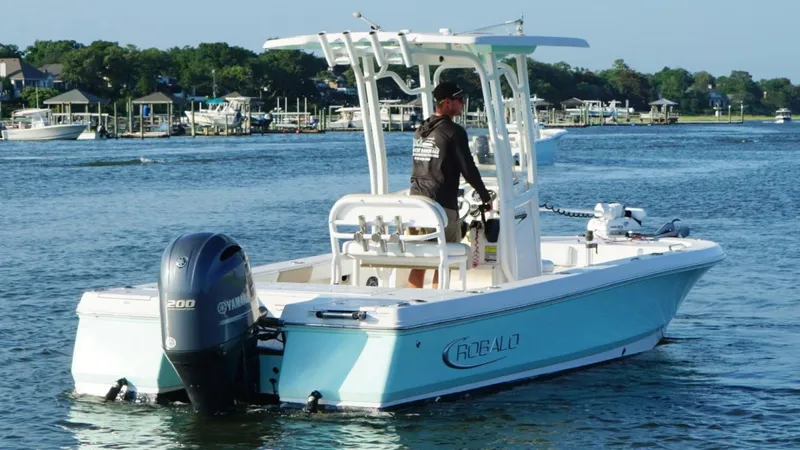 Slide: The Image of 2020 Robalo 226 Cayman boat with Yamaha engine on a calm waterway. - 7