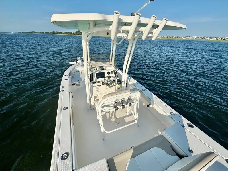Slide: The Image of 2020 Robalo 226 Cayman boat on calm water, featuring a sleek design and modern console. - 9