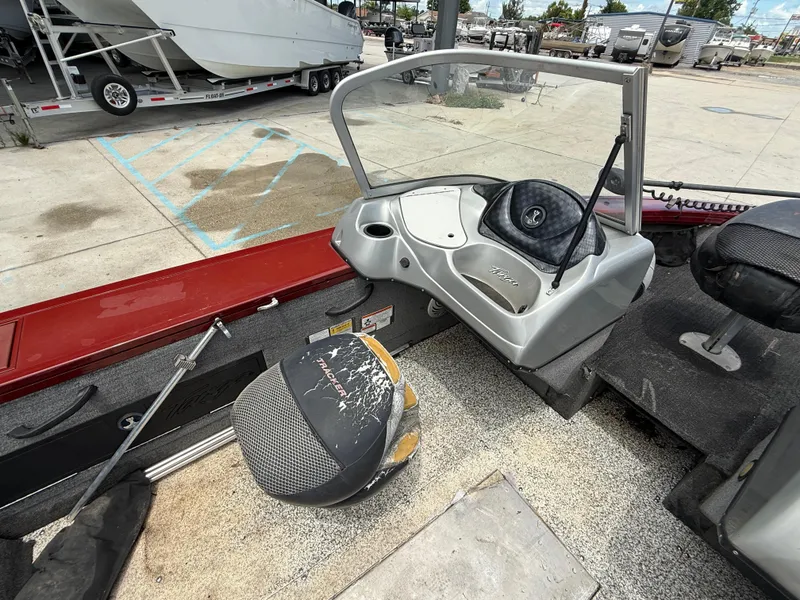 Slide: The Image of 2015 Tracker Targa V18 Combo boat interior with red trim and fishing equipment. - 10